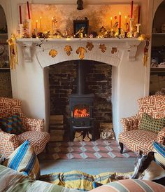 a living room filled with furniture and a fire place in the middle of it's fireplace