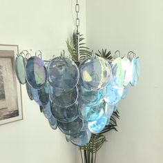 a chandelier hanging from the ceiling in a room with pictures on the wall