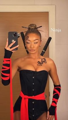 a woman in a black and red corset taking a selfie