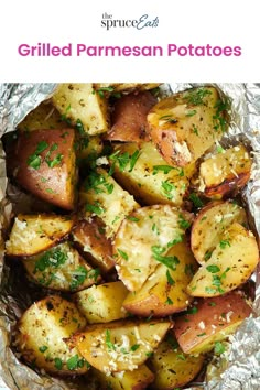 grilled parmesan potatoes in foil with herbs on top and text overlay that reads grilled parmesan potatoes