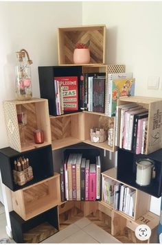 the bookshelf is made out of wooden boxes