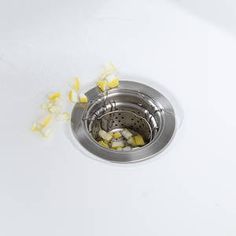 a sink drain filled with yellow and white flowers