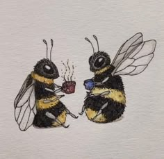 two bees sitting next to each other drinking coffee