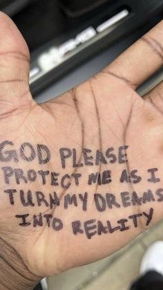 a hand with writing on it that says god please protect me as i turn my dreams into reality