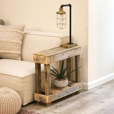 a living room with a white couch and wooden table next to a lamp on top of it