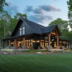 a large black house with lots of windows on it's roof and front porch