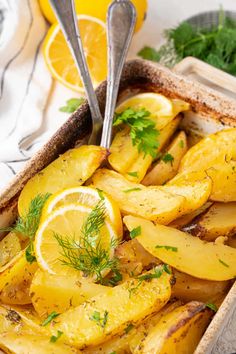 baked potatoes with lemons and herbs in a baking dish, ready to be eaten