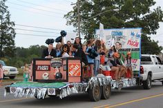 a group of people riding on the back of a truck