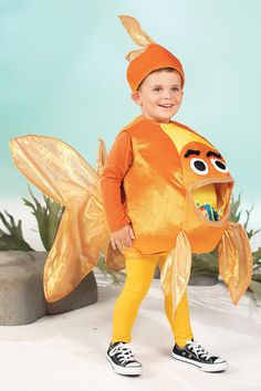 a little boy in a costume that has a fish on it's chest and legs