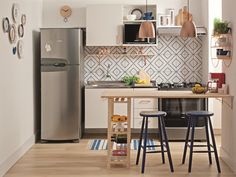 a kitchen with two stools and a table