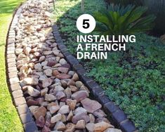 some rocks and grass in the middle of a garden with text overlay reading 5 installing a french drain