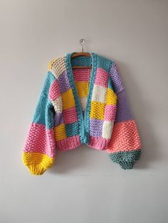 a multicolored sweater hanging on the wall