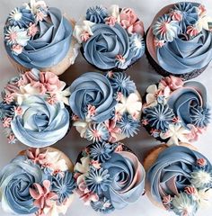 cupcakes decorated with blue frosting and pink flowers