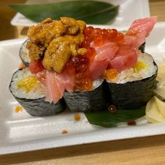 sushi is served on a white plate with garnishes