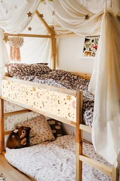 a bunk bed with curtains and pillows on it