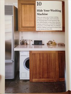 a kitchen with wooden cabinets and a washing machine next to it's dryer