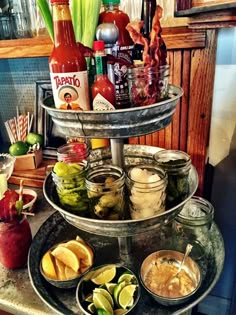 an assortment of condiments are arranged on a three - tiered platter