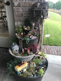 a potted planter filled with lots of different types of plants and small figurines