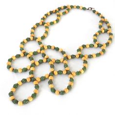 Infuse your wardrobe with coastal charm through this Green Bib Statement Necklace, accentuated with blonde wood and paper beads. Crafted from eco-friendly and upcycled materials, this accessory embodies a commitment to sustainability. With its bohemian boho beach style vibes, this necklace adds a touch of natural allure to any ensemble, reflecting a conscious appreciation for the environment while exuding a relaxed and effortlessly chic aesthetic. This necklace is composed of beads that have bee Paper Beads Necklace, Paper Bead Jewelry, Blonde Wood, Paper Beads, Green Necklace, Boho Beach, Long Chain, Beach Style, Wood Beads