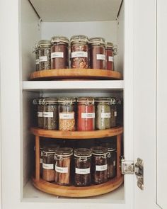 an organized pantry with jars and spices