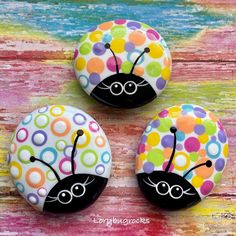 three buttons with colorful polka dots and a ladybug design on the bottom one