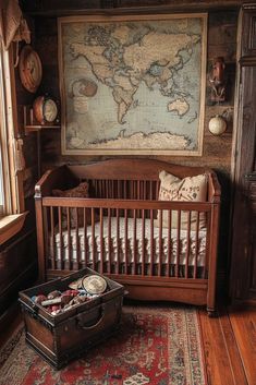 a baby's room with a world map on the wall and an antique trunk