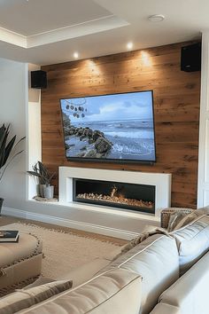 a large flat screen tv mounted on the wall above a fireplace in a living room