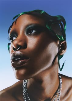 a woman with green hair and jewelry on her neck