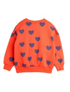 Sweatshirt with an all over Hearts print, made from 100 % GOTS certified organic cotton. Designed for a relaxed fit with dropped shoulders and finished with ribbed elastic trims. Multicolor Heart Print Crew Neck Top, Casual Sweatshirt With Heart-shaped Graphic Print, Playful Red Cotton Sweatshirt, Cotton Sweatshirt With Heart Graphic, Long Sleeve, Casual Multicolor Heart Print T-shirt, Hearts Print, Heart Sweatshirt, Baby Bottoms, Mini Rodini