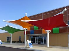 an outside view of a building with colorful awnings