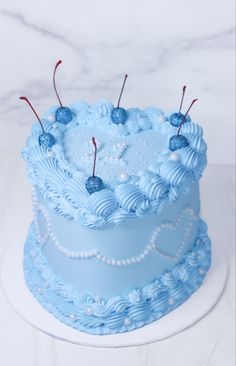 a cake with blue frosting and red pins on top