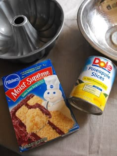 cake ingredients are sitting on a table next to metal pans and baking utensils