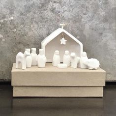 a nativity scene is displayed in front of a stone wall with a star on it