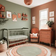 a baby's room with green walls and orange accents