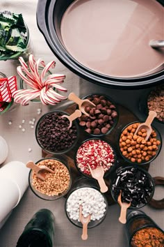 a table topped with bowls filled with different types of candy canes and candies