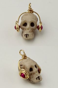 two small skulls with red eyes and gold ear wires