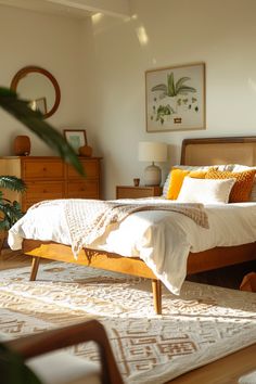 a bedroom with a bed, dresser and rugs in it's center area