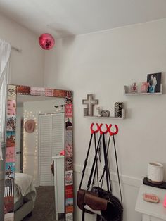 a room with a mirror, coat rack and other items on the wall in front of it