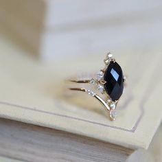 a black diamond ring sitting on top of a book