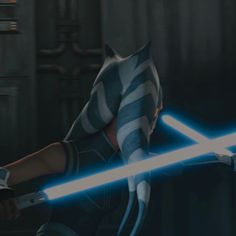 an animated star wars character holding a light saber