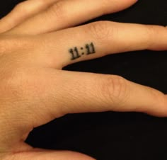 a person's hand with a small tattoo on the middle finger that says it all