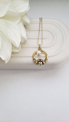 This necklace sports the traditional Celtic Claddagh symbol in a charm representing love, loyalty, and friendship. The necklace is simple in design yet elegant and lovely in all styles. The charm and additional vintage pearl dangle from your choice of a 16" or 18" matching chain with a 3" extender. Both the silver and gold charms are the same size. This is the perfect gift for your best friend, Mom, sister, or that special someone. Welcome to Recycled Finery!  I repurpose old jewelry, coins, bea Symbolic Vintage Charm Necklace For Gift, Symbolic Charm Necklaces With Vintage Charm For Gifts, Traditional Irish Jewelry, Irish Jewelry Celtic Designs, Irish Jewelry Necklaces, Claddagh Symbol, Art Nouveau Necklace With Vintage Charm For Gifts, Claddagh Necklace, Irish Claddagh