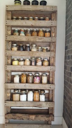 a wooden shelf filled with lots of jars