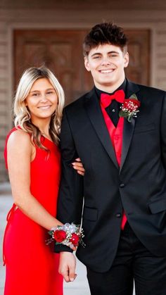 a young man and woman dressed in formal wear