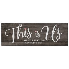 this is us wood sign with hearts on the front and bottom, in white lettering