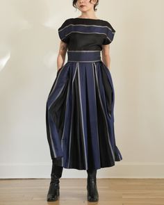 "Classic and iconic skirt set c. 1980s Perry Ellis. High quality black and blue colorblock striped silk. Boxy cut, short-sleeved boatneck top with button closure at left shoulder. Box pleated midi skirt with slip pockets at hips. Button closure at waistband. composition: 100% silk label: Perry Ellis made in USA condition: excellent tag size: 4 (top) 10 (skirt) modern size estimate: small - medium (please refer to measurements for proper fit) MEASUREMENTS top: bust - 36\" waist - 34\" hips - 38\" length - 24\" skirt: waist - 28\" hips - 42\" length - 35\" *measurements taken flat - doubled for bust, waist, and hips shown unpinned on model - 5'4\", size xs/small all sales final - please review our shop policies prior to purchase" Two Piece Matching Set, Skirt Two Piece, Aran Sweater, Stripe Silk, Perry Ellis, Indian Cotton, Dress Purchase, Silk Skirt, Pleated Midi Skirt