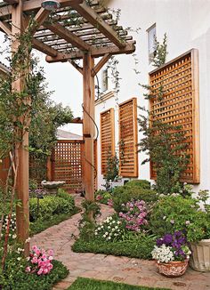 an outdoor garden with flowers and greenery