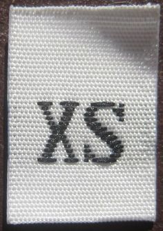 a white cloth with the letter xs on it