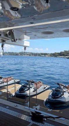 several motor boats are parked on the deck of a boat in the open water,