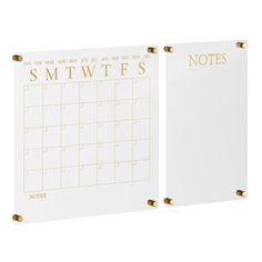 two white memos with gold lettering on the front and back of each notepad